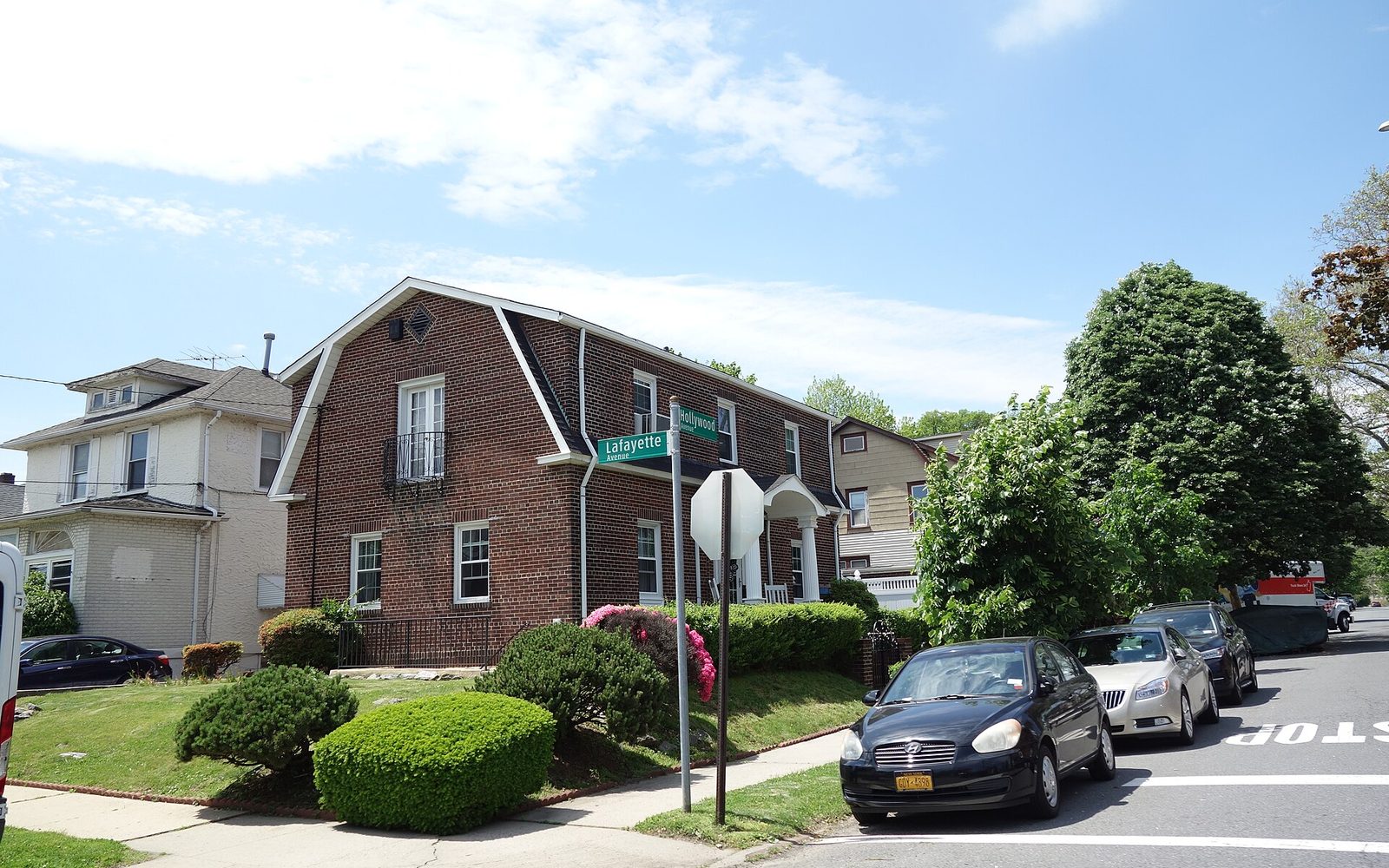 Two-family brick house on Lafayette Avenue in Throggs Neck, the Bronx, on a sunny day
